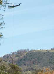 Helicopter
                      N216AP lifting PG&E pole - 2024 March 18
                      working with N410AP.